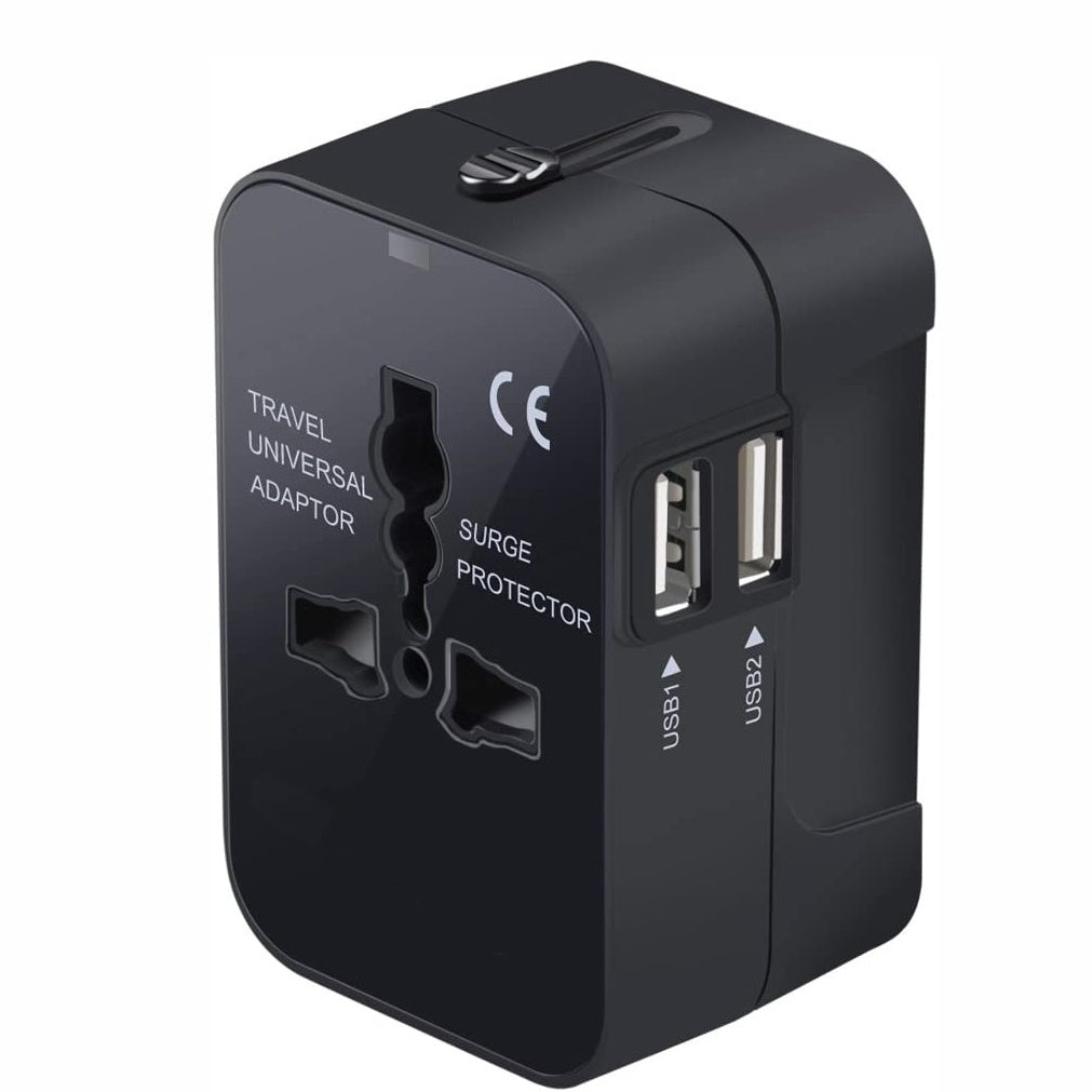 Black travel universal adapter with USB ports on a white background