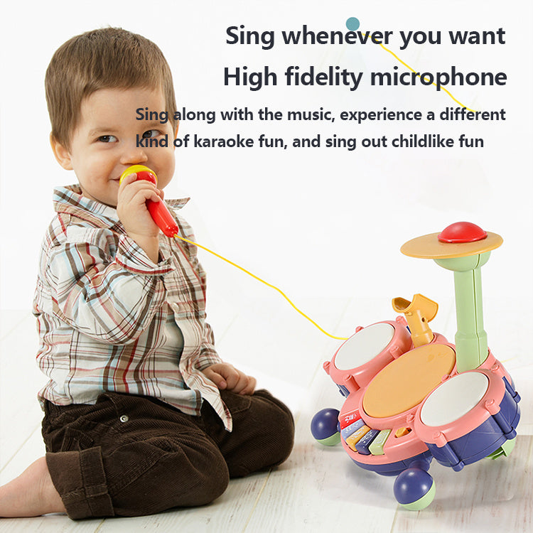 Child playing with a toy microphone and drum set on a white background