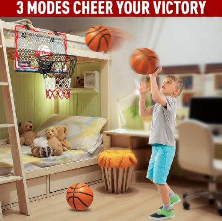 Child playing with basketballs and a mini basketball hoop in a room with teddy bears and a bed.